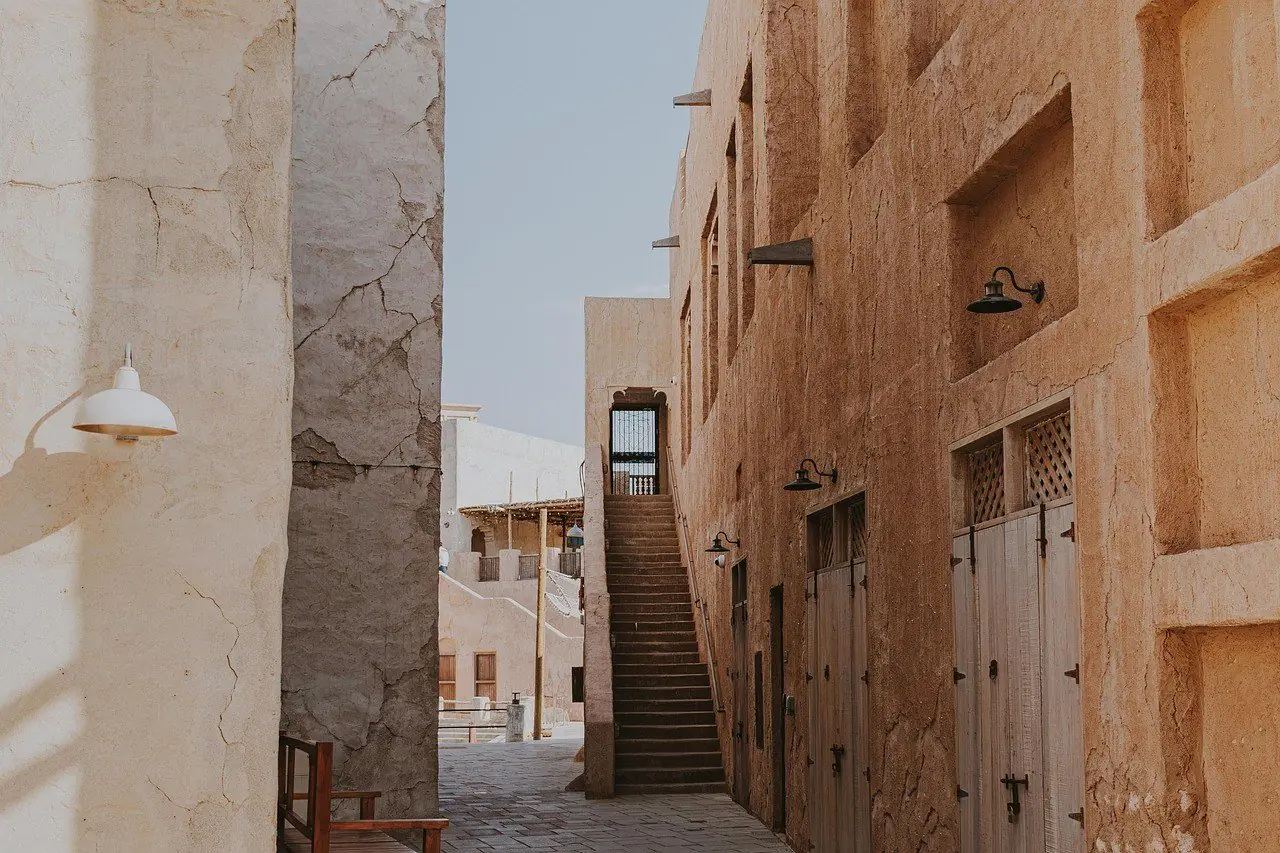 Narrow lane between old sand coloured buildings in Dubai
