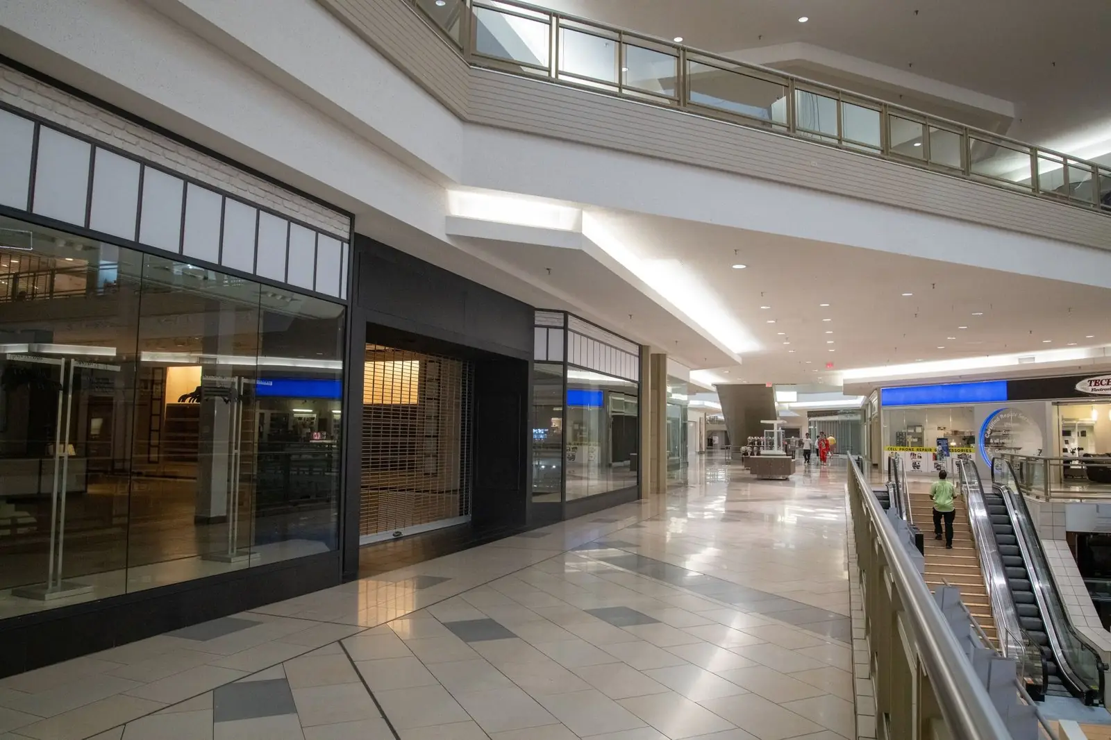 Quiet shopping mall walkway beside escalators