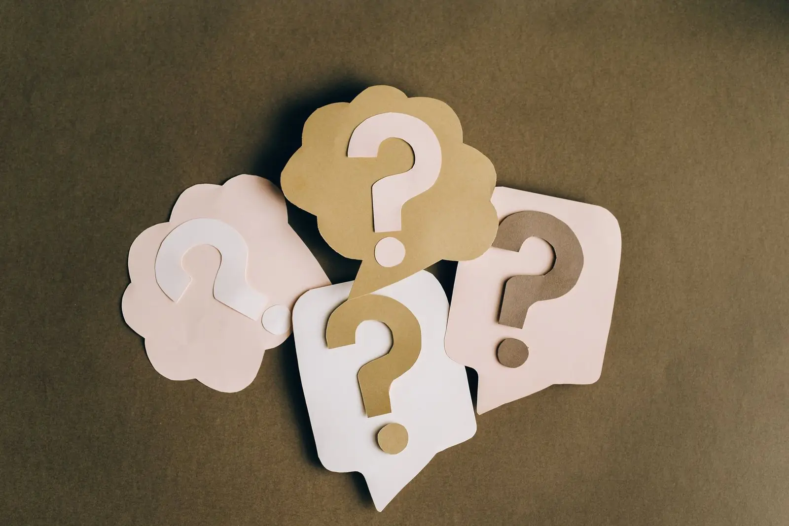 Paper speech bubbles with question marks