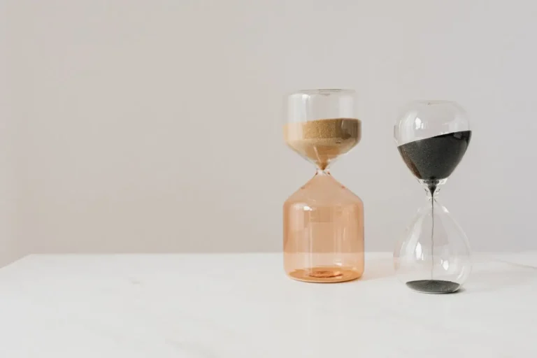 Two hourglasses on a white table
